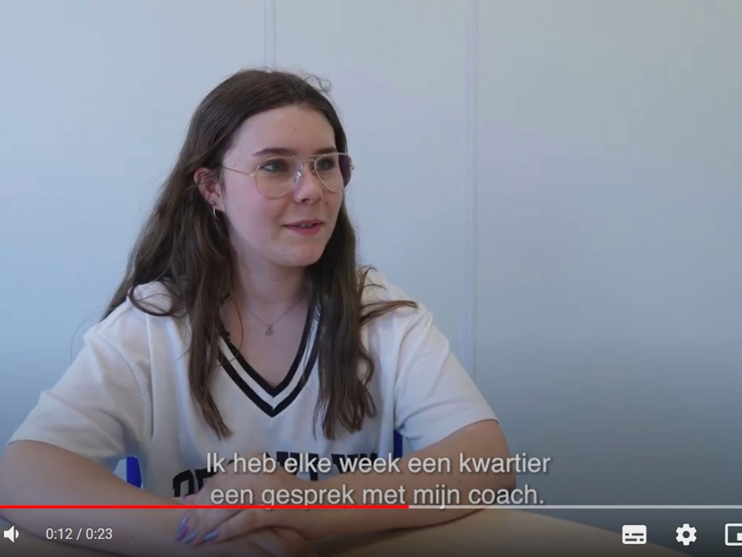 Leerling lachend voor een boekenkast