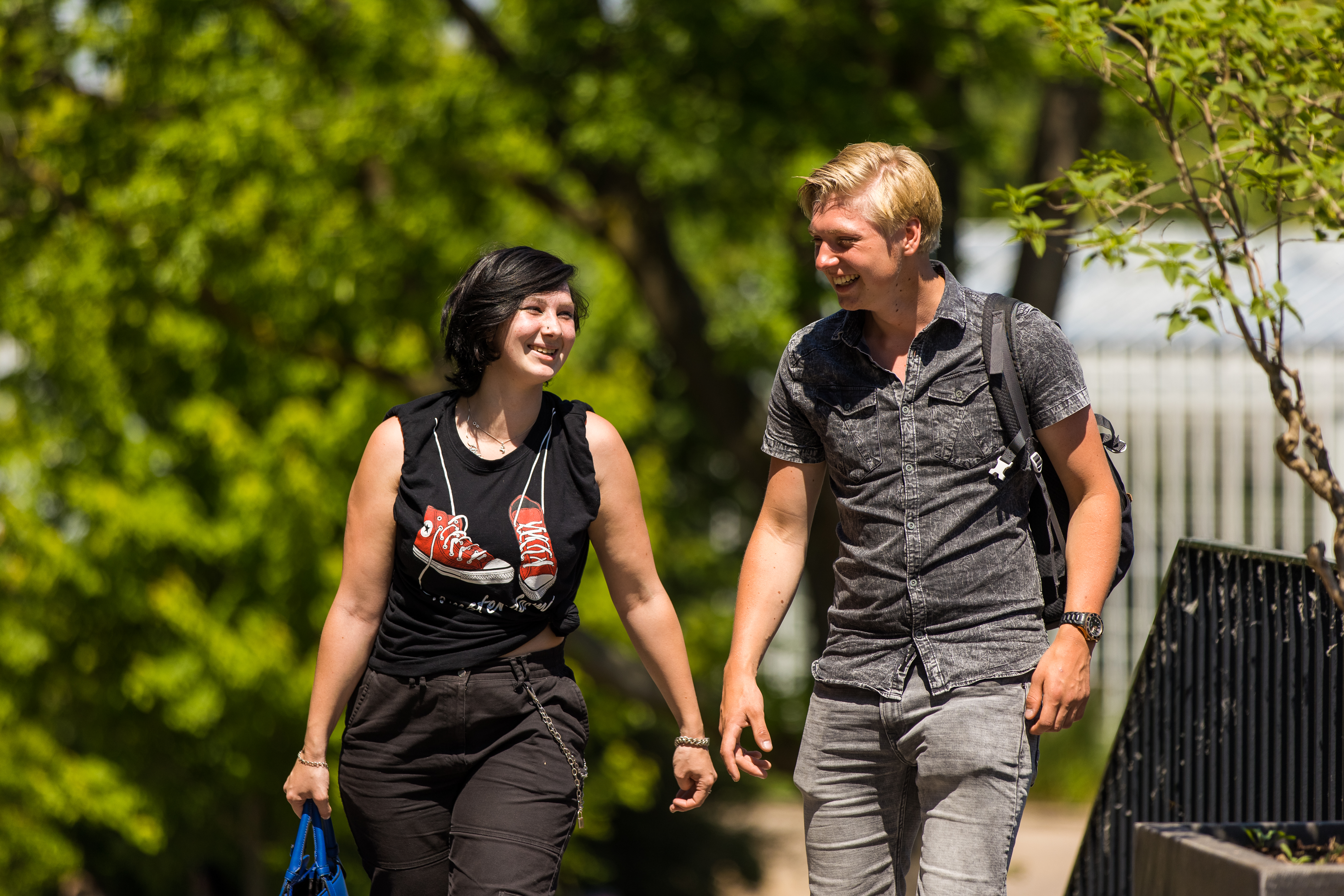 Twee leerlingen lopen samen in een groene omgeving