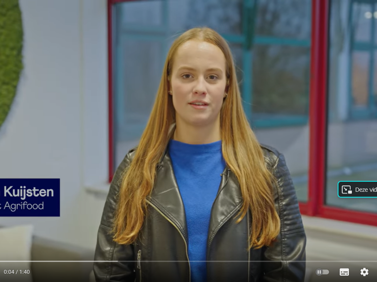 Leerling lachend voor een boekenkast