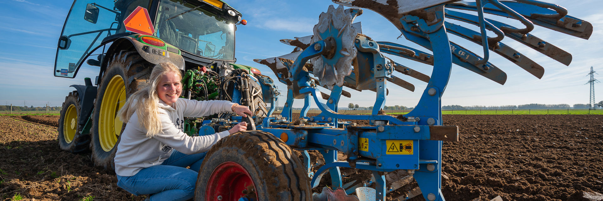 Een student werkt aan een tractor aanhanger