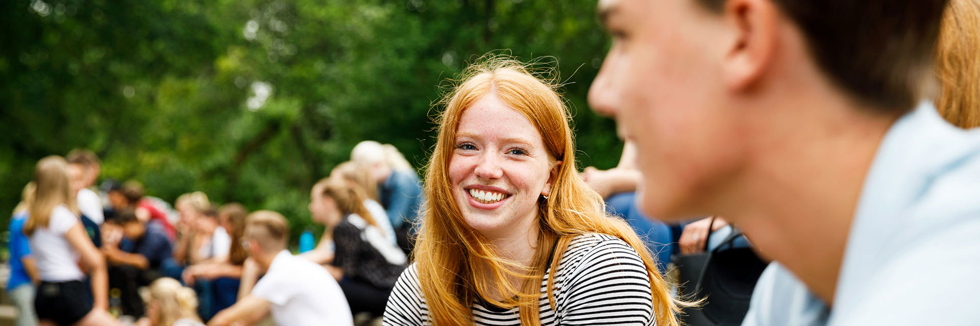 Een lachende student buiten
